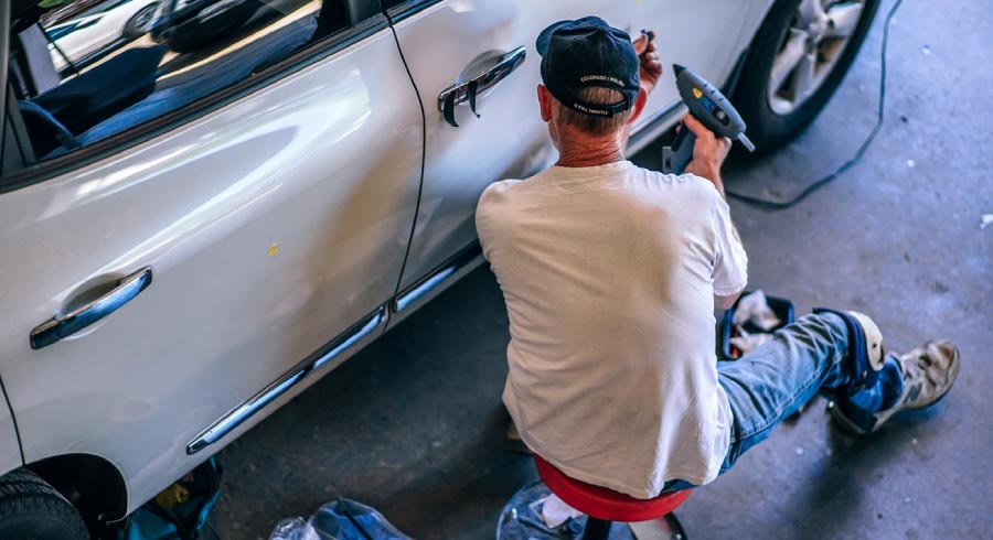 Man working on a car door