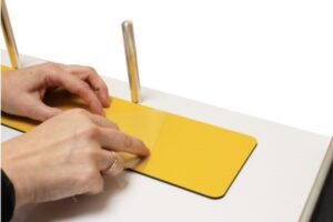 Fold back a few centimetres and crease the adhesive cover